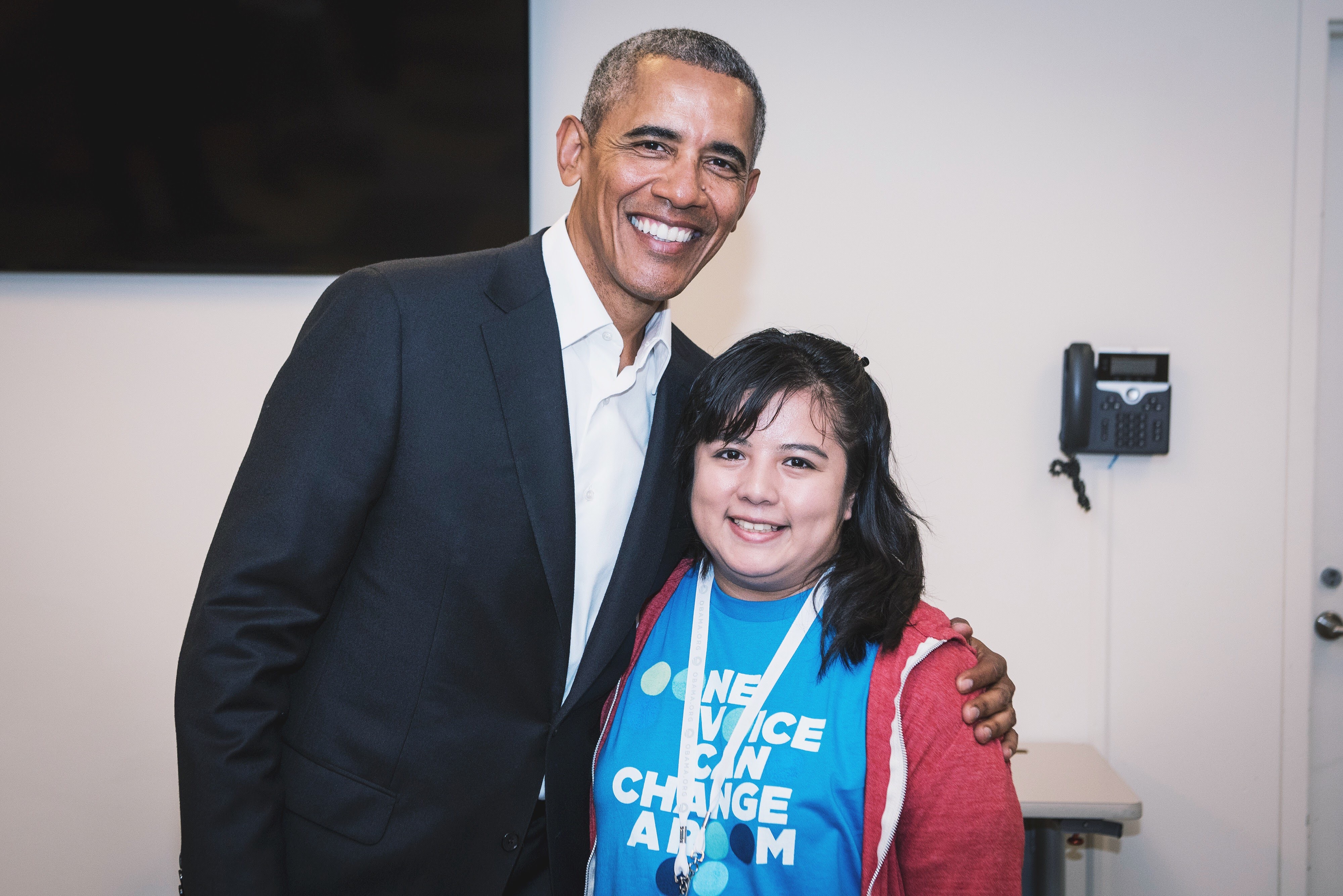 Cecilia posing for a photo with former president Barack Obama